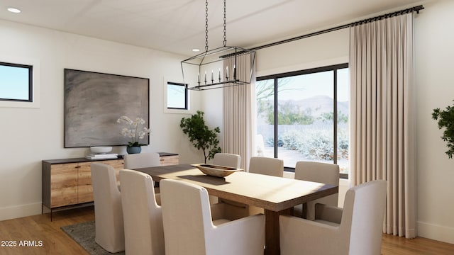 dining room with light wood-style floors, recessed lighting, a notable chandelier, and baseboards