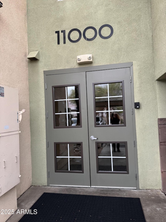 doorway to property with stucco siding