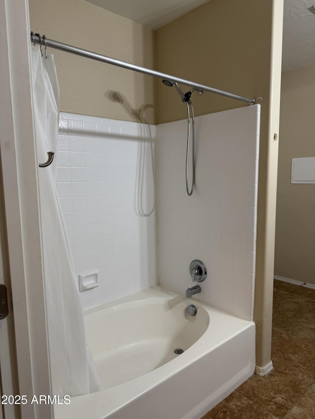 full bathroom featuring shower / bath combination with curtain and baseboards