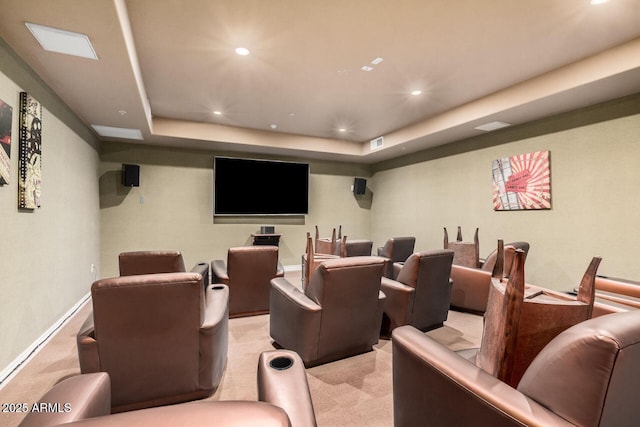 home theater with a tray ceiling, recessed lighting, visible vents, and light colored carpet