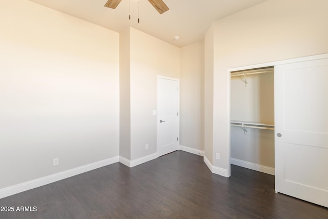 unfurnished bedroom featuring dark wood-type flooring, ceiling fan, and a closet