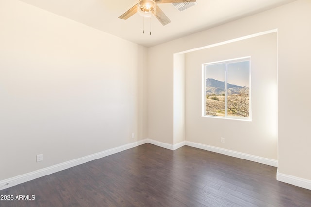 spare room featuring dark hardwood / wood-style flooring and ceiling fan