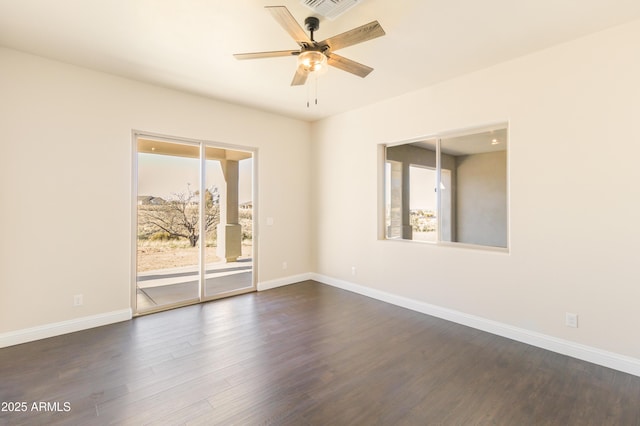 empty room featuring plenty of natural light, dark hardwood / wood-style floors, and ceiling fan