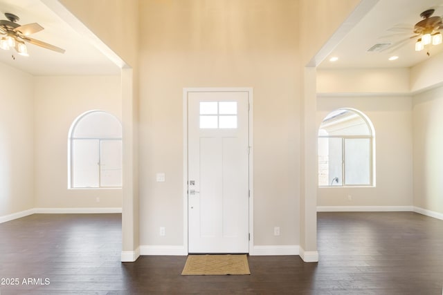 entrance foyer with dark wood-type flooring, a wealth of natural light, and ceiling fan