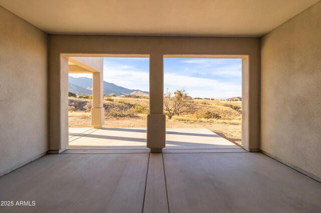 interior space featuring a mountain view and light hardwood / wood-style flooring