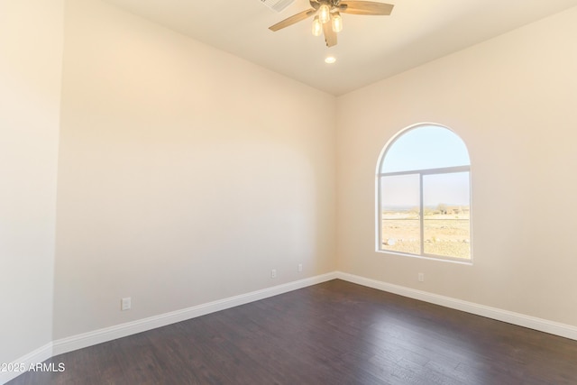 spare room featuring ceiling fan and dark hardwood / wood-style flooring