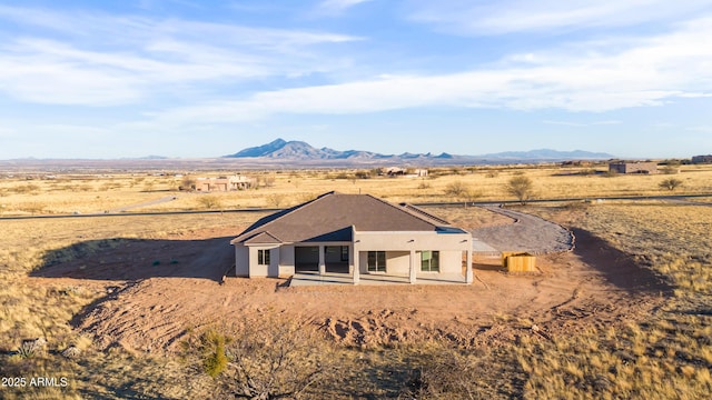 rear view of house featuring a mountain view and a rural view