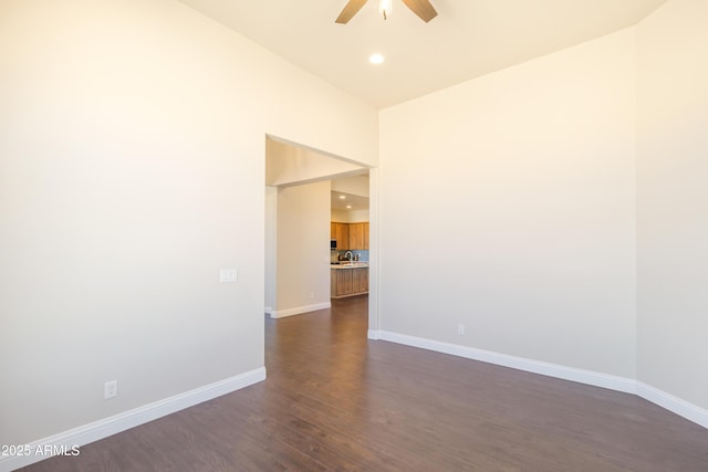 unfurnished room with dark hardwood / wood-style flooring and ceiling fan