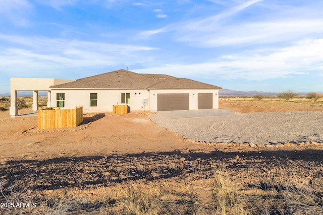 rear view of property featuring a garage