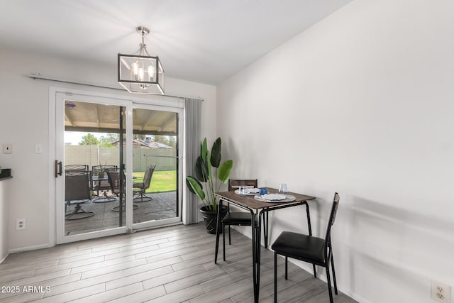 19031 N 13th Dr, Phoenix, AZ 85027 - dining room featuring wood finished floors, a chandelier, and baseboards