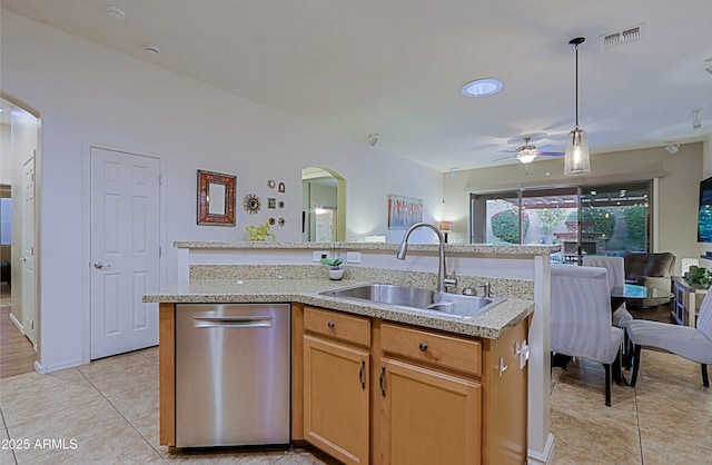 kitchen with stainless steel dishwasher, a sink, arched walkways, visible vents, and a ceiling fan