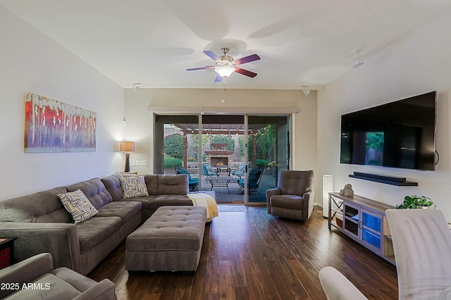living area with hardwood / wood-style flooring and a ceiling fan