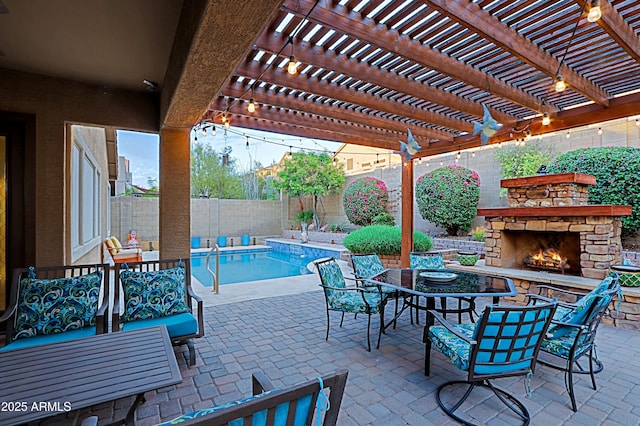 view of patio / terrace featuring a fenced backyard and an outdoor stone fireplace