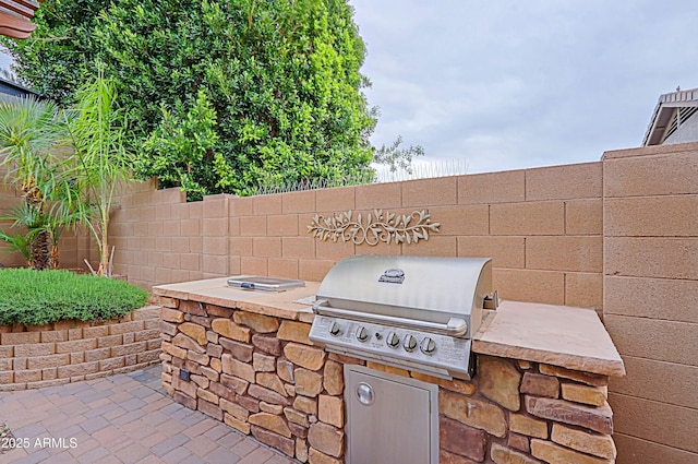 view of patio with fence and area for grilling