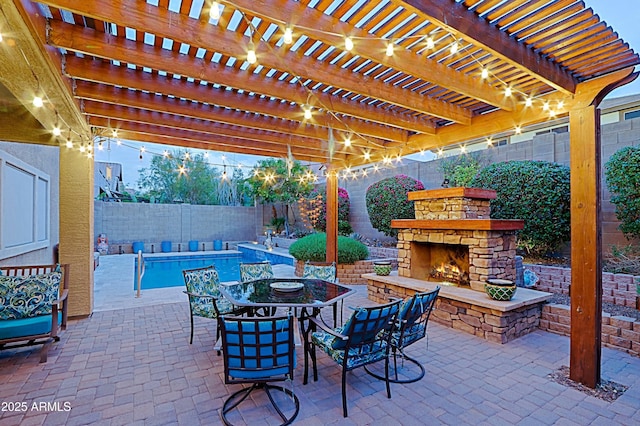 view of patio featuring a fenced backyard, outdoor dining area, and an outdoor stone fireplace