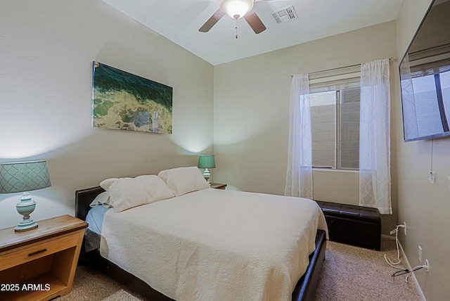 carpeted bedroom with baseboards, visible vents, multiple windows, and a ceiling fan