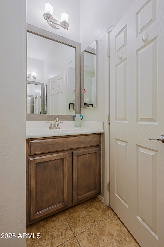 bathroom with tile patterned flooring and vanity