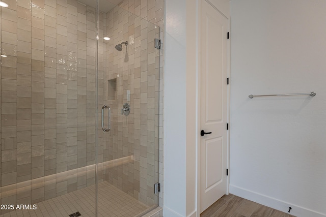 21411 W Meadowbrook Ave, Buckeye, AZ 85396 - full bathroom featuring a stall shower and wood finished floors