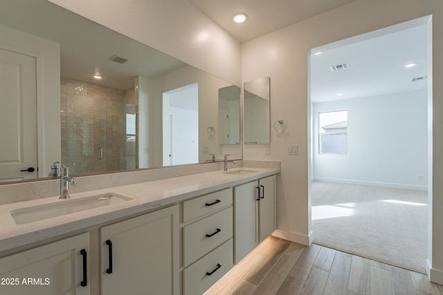 21411 W Meadowbrook Ave, Buckeye, AZ 85396 - full bath featuring double vanity, wood finished floors, a shower stall, and recessed lighting