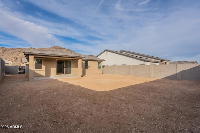 21411 W Meadowbrook Ave, Buckeye, AZ 85396 - back of property with a fenced backyard, stucco siding, and a patio area