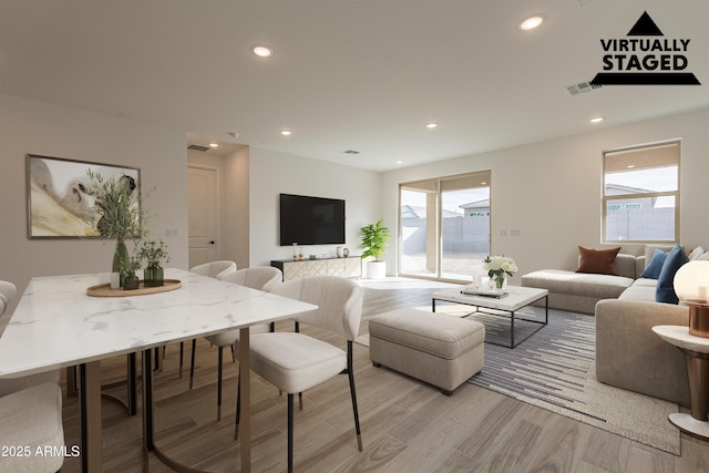 21411 W Meadowbrook Ave, Buckeye, AZ 85396 - living area featuring light wood-style floors, healthy amount of natural light, and recessed lighting