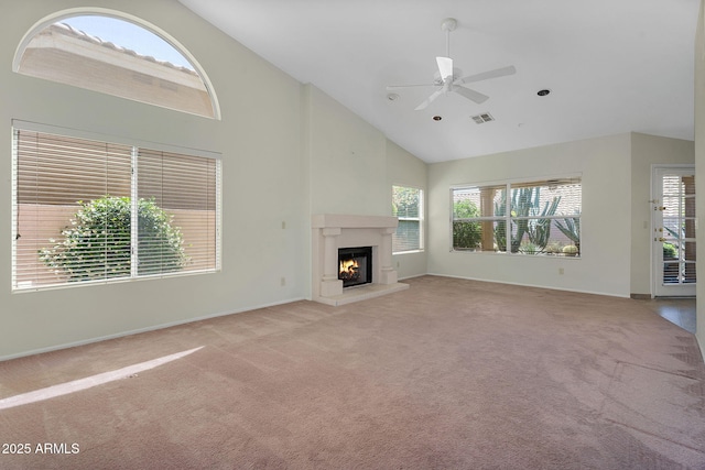 unfurnished living room featuring carpet floors, high vaulted ceiling, a premium fireplace, a ceiling fan, and baseboards
