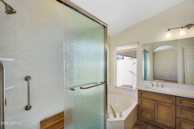 full bath featuring a shower stall, vaulted ceiling, a bath, and vanity
