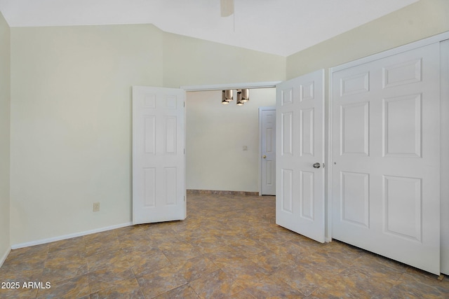 unfurnished bedroom with lofted ceiling, baseboards, and a ceiling fan