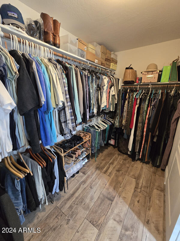 spacious closet featuring hardwood / wood-style flooring