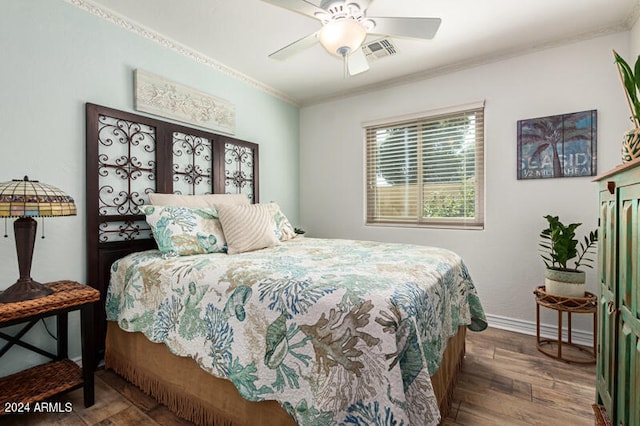 bedroom featuring ceiling fan, dark hardwood / wood-style floors, french doors, and crown molding