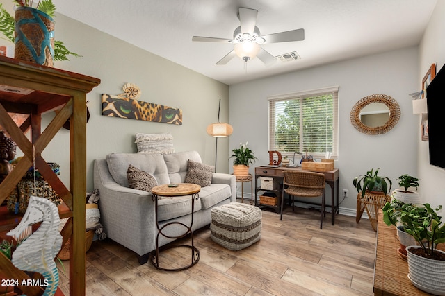 living area with ceiling fan and light hardwood / wood-style flooring