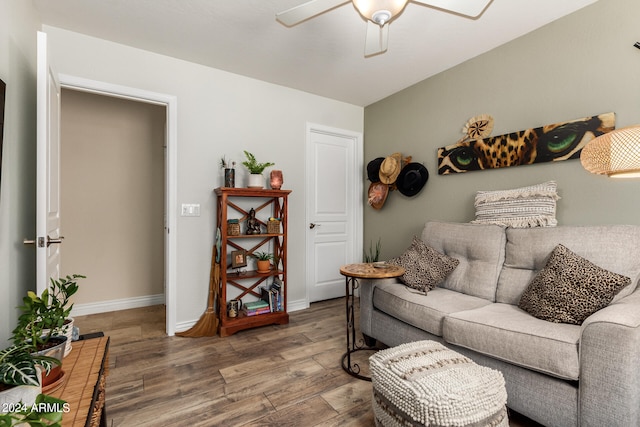 living room featuring hardwood / wood-style floors and ceiling fan