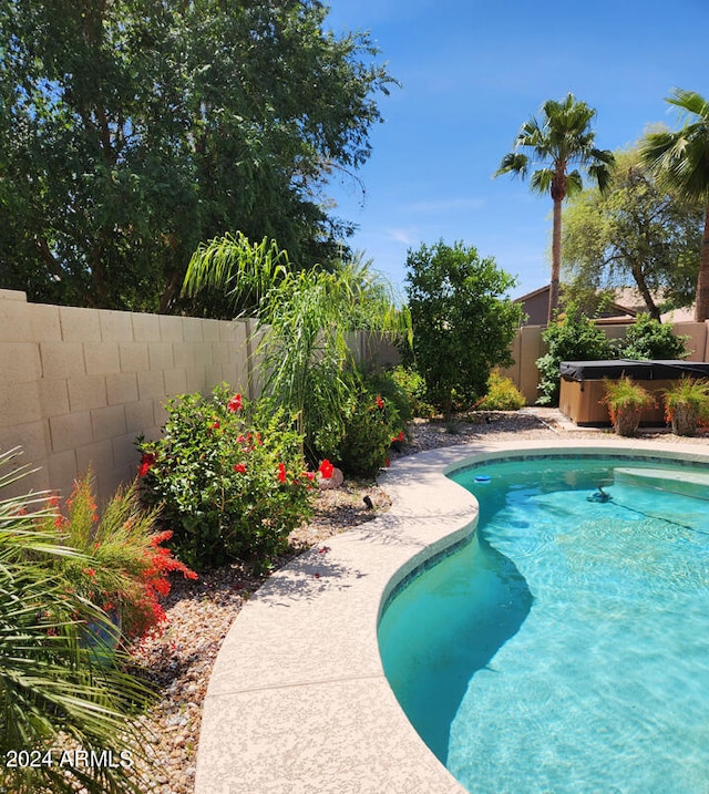 view of pool featuring a hot tub