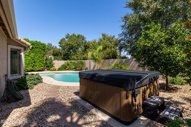 view of pool with a hot tub