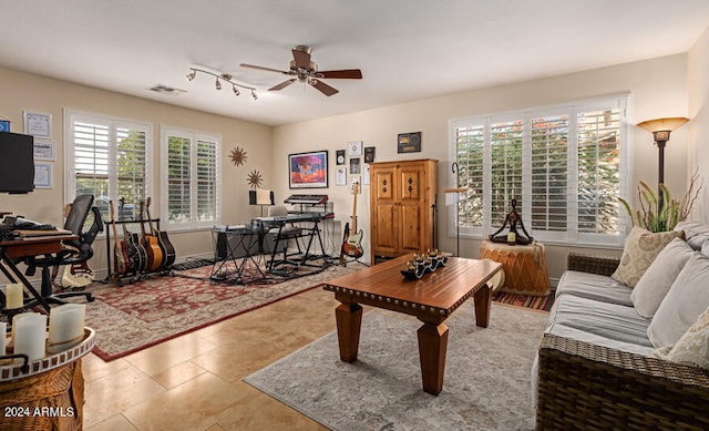 living room with light tile patterned floors and ceiling fan