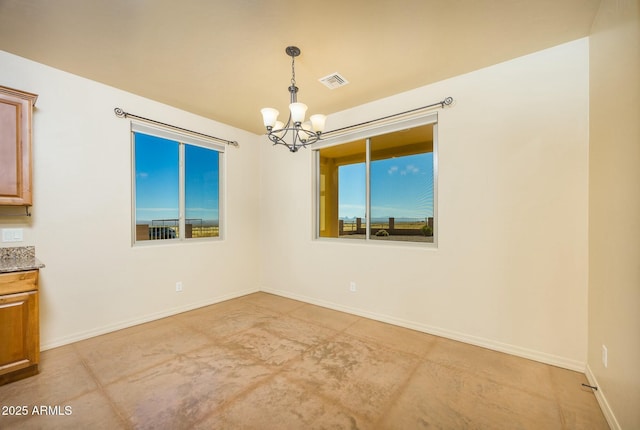 unfurnished dining area with plenty of natural light and a chandelier