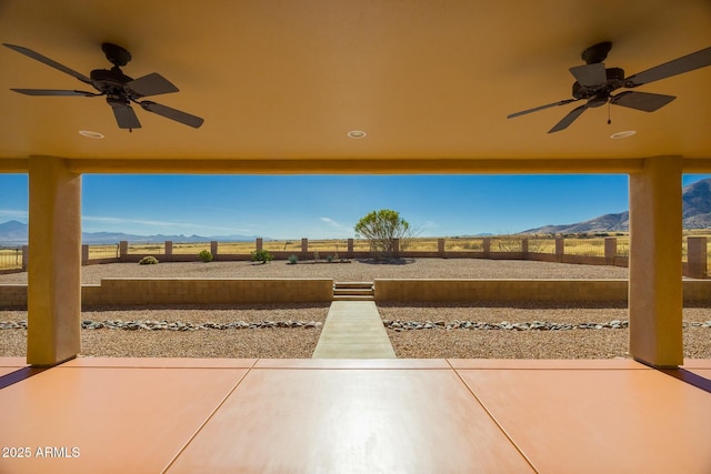 view of patio featuring a mountain view and ceiling fan