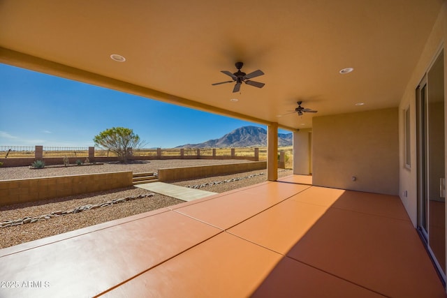 view of patio / terrace featuring a mountain view and ceiling fan