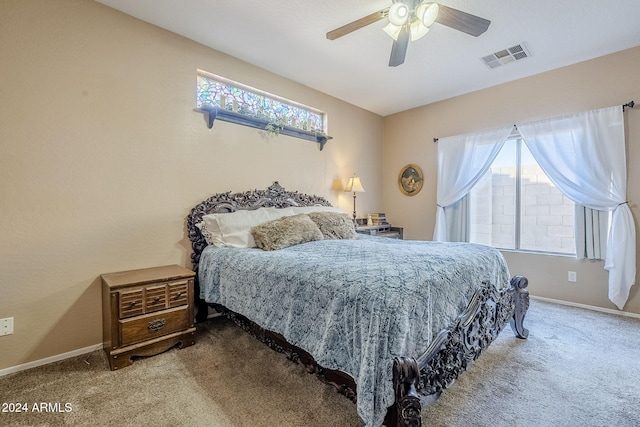 bedroom with carpet flooring, ceiling fan, and multiple windows