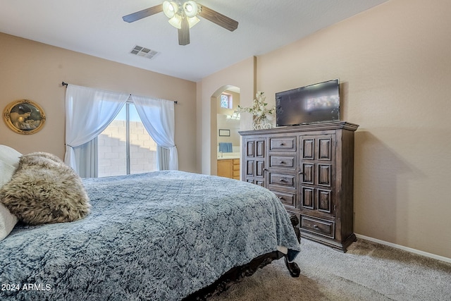 carpeted bedroom featuring ceiling fan and connected bathroom