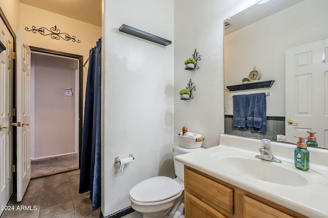 bathroom featuring tile patterned flooring, vanity, and toilet