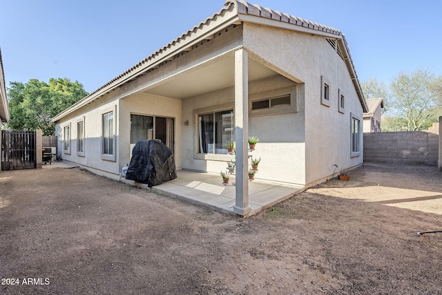 back of house with a patio area