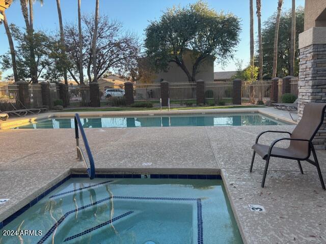 view of pool with an in ground hot tub