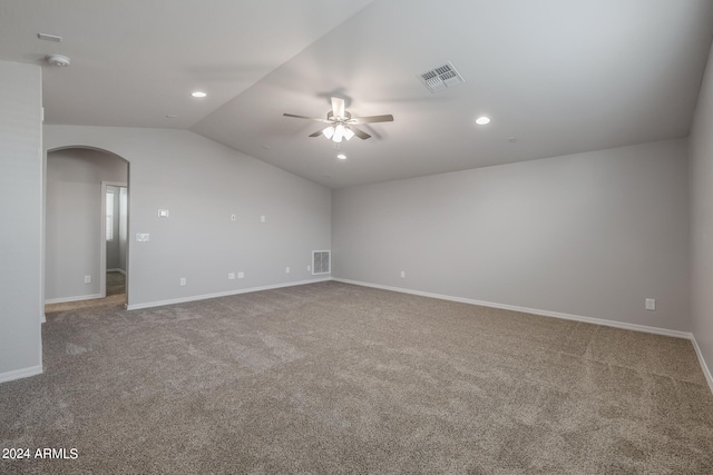 empty room with carpet flooring, ceiling fan, and vaulted ceiling