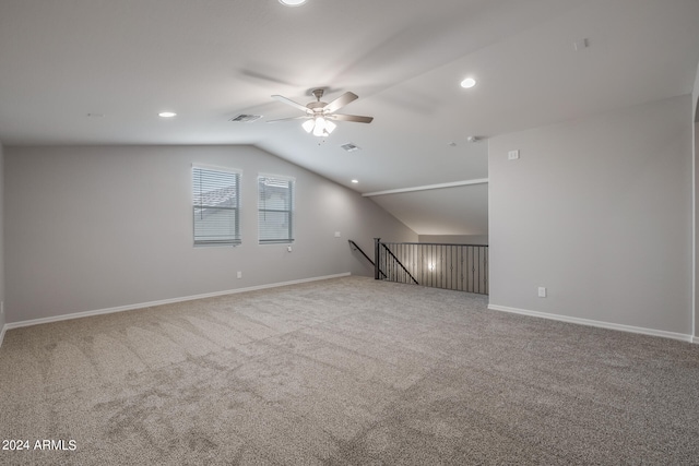 unfurnished living room with ceiling fan, carpet floors, and vaulted ceiling