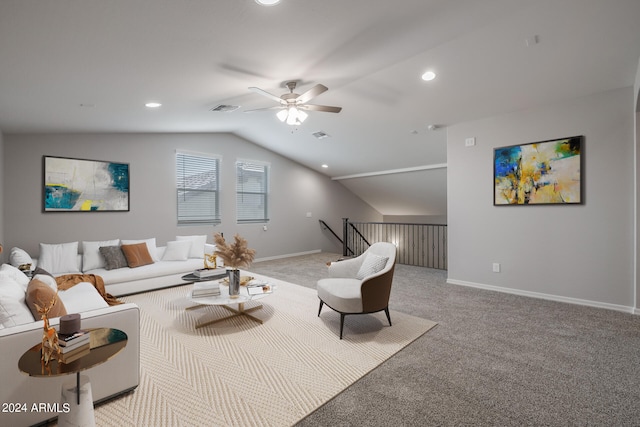 living room featuring ceiling fan, carpet flooring, and lofted ceiling