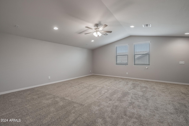 empty room with carpet, ceiling fan, and vaulted ceiling