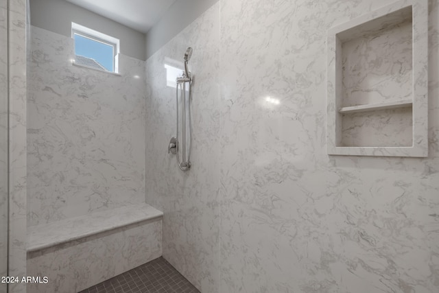 bathroom featuring a tile shower