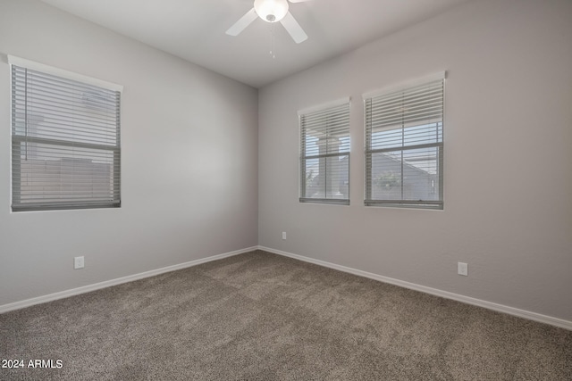 carpeted spare room with ceiling fan