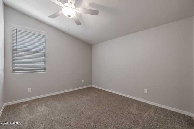 carpeted empty room featuring lofted ceiling and ceiling fan